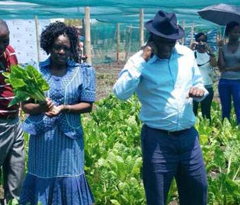 Joyce Sibeko, Chairperson of Ikemiseng Association for the Blind, gives Deputy Minister of Agriculture, Forestry and Fisheries Bheki Cele a tour of their project.