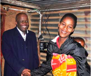Photo caption: Ekurhuleni Executive Mayor Mondli Gungubele shares a moment with resident Ann Van Heerden, who is all smiles after she became one of the beneficiaries of a solar lighting project.
