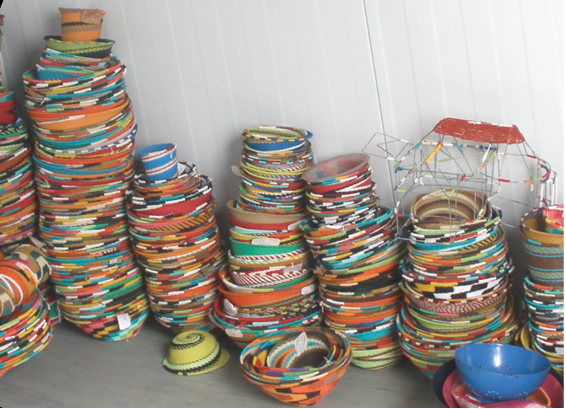 Photo caption: Virginia Semango displays bowls made by women from Muyexe Arts and Craft.
