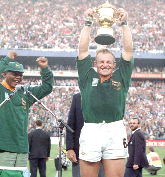Photo caption: Former President Nelson Mandela celebrates with former Springbok captain Francois Pienaar after the team won the 1995 Rugby World Cup.