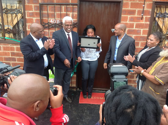 Nomalungelo Mkhize looking at her certificate confirming her ownership of the house at Sithembile, Glencoe northern of KwaZulu-Natal.