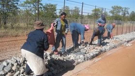 Local people were employed to erect a fence on the border between Muyexe village and the Kruger National Park to protect the community and their livestock 