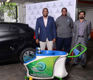 Deputy Minister in The Presidency, Buti Manamela, Carwash Supreme owner Mbongeni Msomi and NYDA Executive Chairperson Yershen Pillay seen here with the equipment used to wash cars.