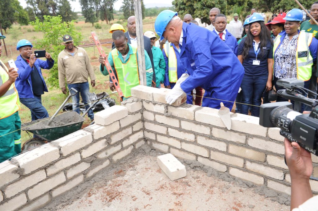 Limpopo Premier Stanley Mathabatha lays a brick during the building phase of Lina Marutha’s new home.
