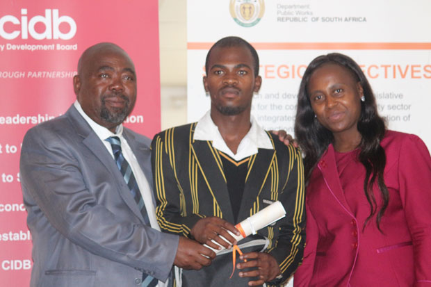 Olwethu Bitterhout's (centre) hard work has paid off. Public Works Minister Thulas Nxesi (left) handed him a bursary that will pay for his studies at the University of Cape.
