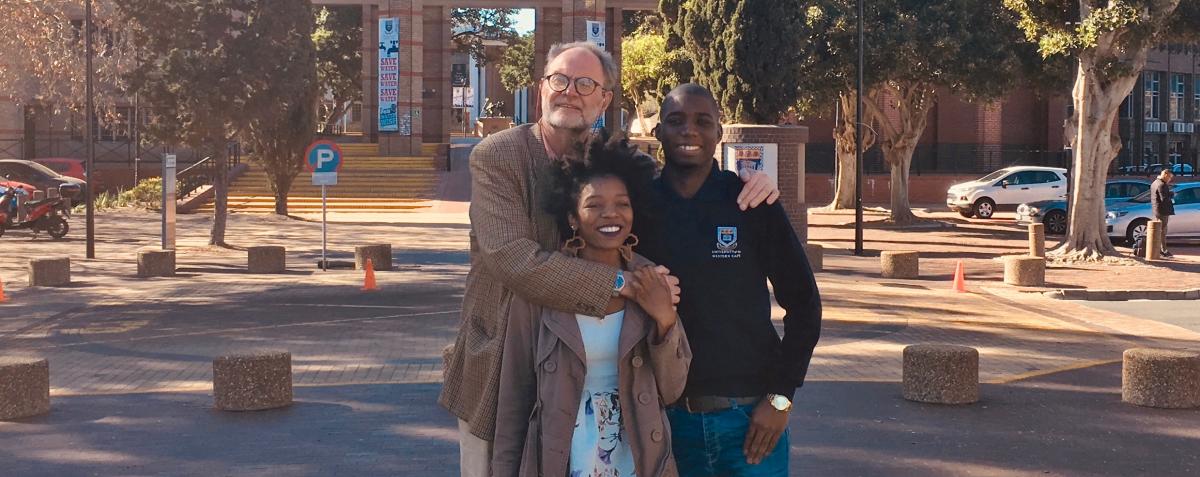 Theo Krynauw with two Sparklekids Tinashe Nyamurowa and Bonke Xakata who are studying at university.