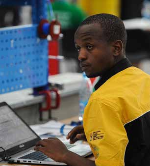 Thabang Modise working on his laptop at the WorldSkills Competition.