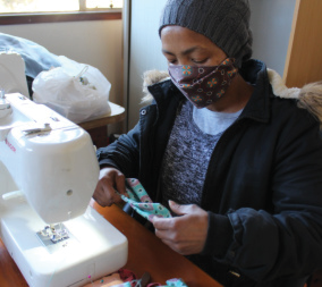 A public-private maskmaking initiative is giving community seamstresses a small income while also providing masks for disadvantaged people.