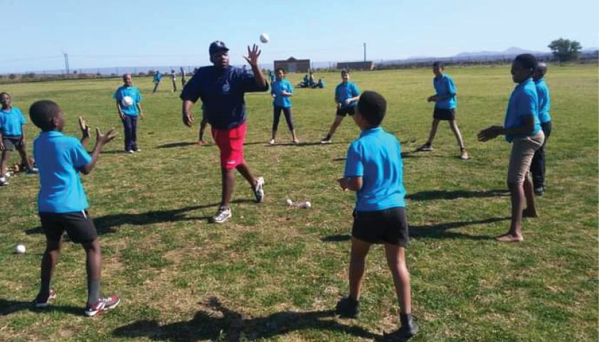 Baseball coach Lwazi Mlondolozi trains young players in the sport.