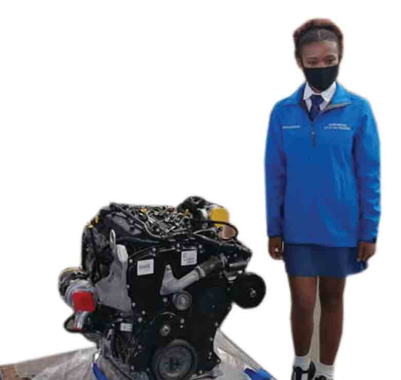 Otto Du Plessis High School pupil Agnes Farret next to an engine donated by Ford to her school.