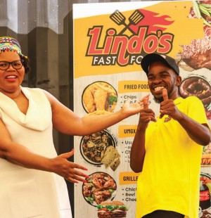 National Empowerment Fund CEO Philisiwe Mthethwa with Lindokuhle Msomi, who received a R400 000 mobile kitchen after his make-shift kiosk was destroyed in the July 2021 unrest.