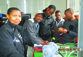 Nyameka Tshangana(left) trains the apprentices at the Mercedes-Benz South Africa Training Academy. Picture: Jobs Fund