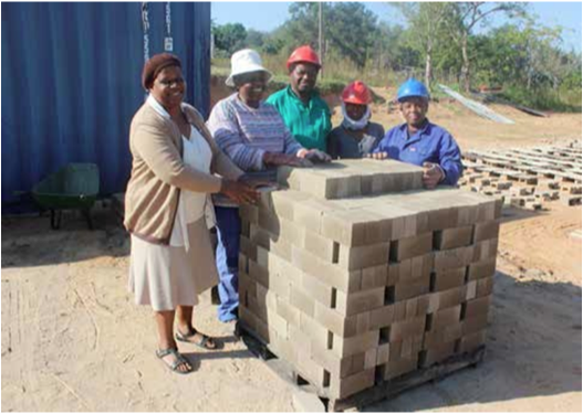 Members of the Tfutfukani Brick making cooperative stand proudly next to the material they produce. The business is doing well and has potential to grow. (Photo: Mduduzi Tshabangu)