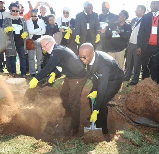 General Secretary of Metropolis Alain Le Saux and Joburg Mayor Parks Tau plant a tree in Sophiatown, with delegates looking on. (Photos: Enoch Lehung)