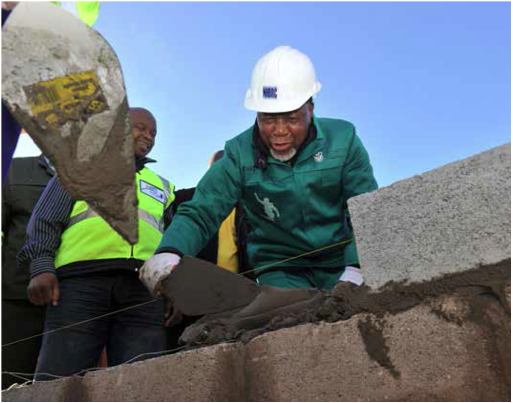 Deputy President Kgalema Motlanthe lends a helping hand during the War on Poverty building drive in Chatty in the Eastern Cape.