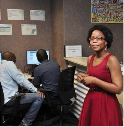 Transnet Enterprise Development Hub Manager Mathebe Tsomele at the reception area of the hub, while clients are on the CIPC website.