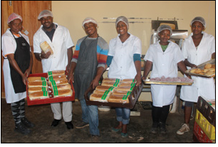 Thulasizwe Shabalala (second from left), one of the founders of the Thuthukamzizi Bakery Cooperative, and his workers have big dreams for their business, which has been put on the path to success thanks to the help of government agencies.