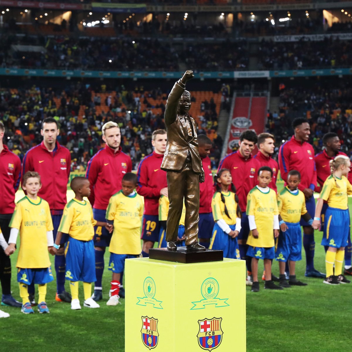 1.	Spanish club Barcelona line up behind the Nelson Mandela Centenary trophy before their clash with PSL winners Mamelodi Sundowns at FNB Stadium in Johannesburg on Wednesday, 16 May 2018. (Picture: Mamelodi Sundowns Facebook page)