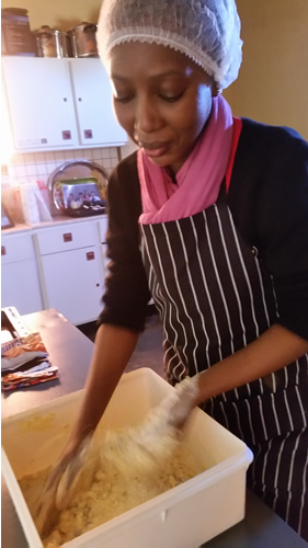 Naledi Tikane baking some of the sweet cakes she will sell to her clients.