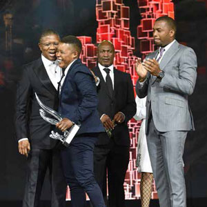 Minister Fikile Mbalula embraces Sport Star of the Year Portia Modise. Last year’s winner Itumeleng Khune looks on.