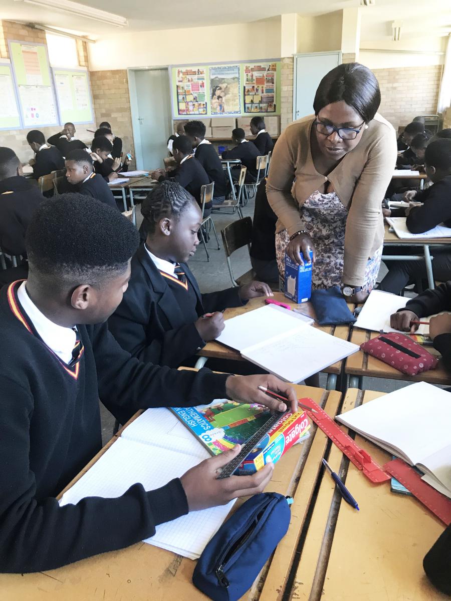 The best maths teacher in the country Mishael Matonhodze emparting knowledge to her grade eight learners.