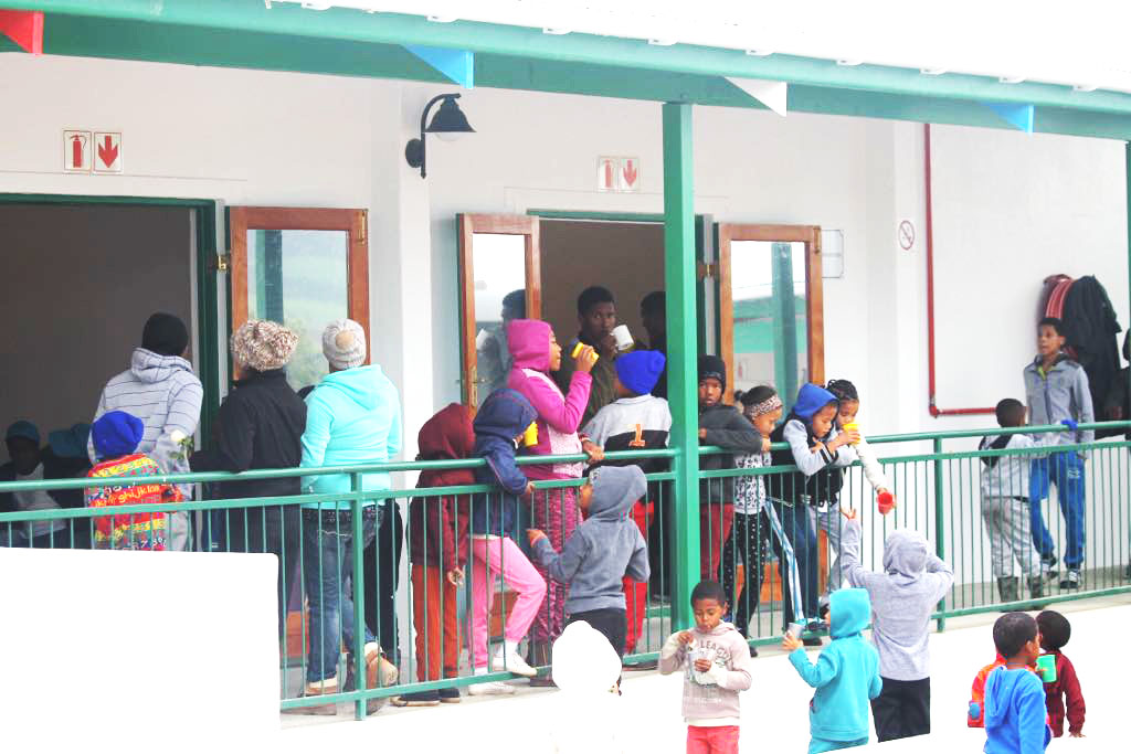 Children playing outside the Path Out of Poverty Youth Centre during the launch.