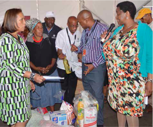 Minister of Social Development Bathabile Dlamini distributing food parcels with CEO of Sassa Virginia Peterson in Phuthaditjhaba