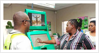 Minister of Communications Faith Muthambi at the launch of Mamelodi Thusong Service Centre. The Minister tested the new infrastructure and interacted (below) with community members at the centre.