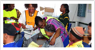 Minister of Communications Faith Muthambi at the launch of Mamelodi Thusong Service Centre. The Minister tested the new infrastructure and interacted (below) with community members at the centre.