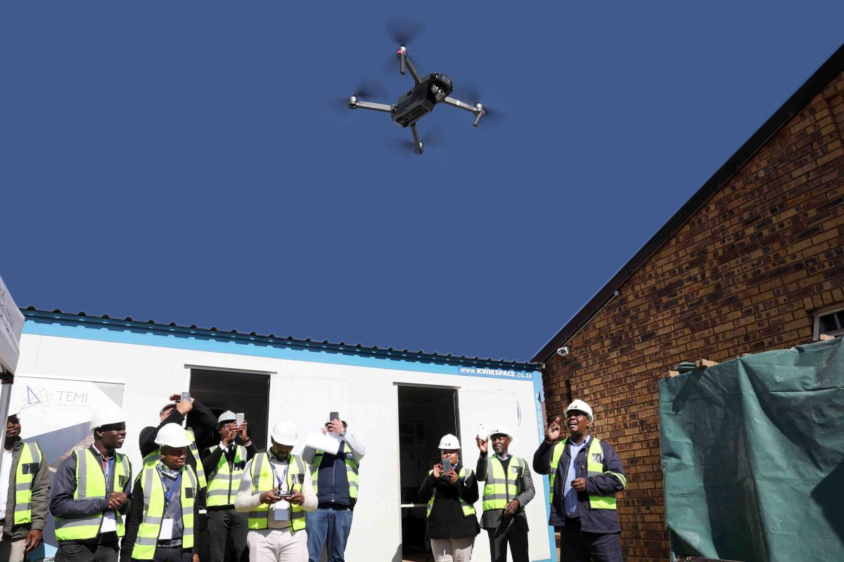 Officials of the DID test flying the drone which is planned to make the monitoring of infrastructure programmes more effective.