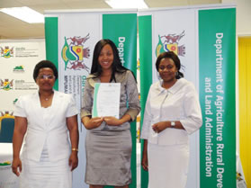 Simangele Mbatha DARDLA Director of Human Resource Development, left, and Hloni Thabethe DARDLA Director Risk and Security Management, right, with intern Nomaswazi Nkosi displaying her certificate.