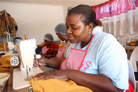Members of Mentloana Sewing Project at work in their sewing room. 