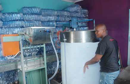 Young entrepreneur Thapelo Magwete alongside his mixing machine where he produces high quality products.
