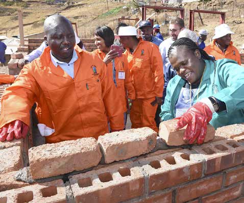 Minister Faith Muthambi helps build one of the houses she promised to five families.
