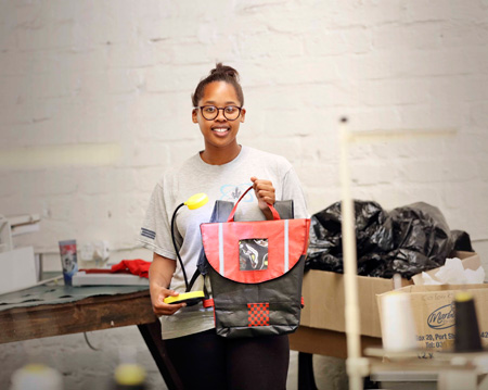 Young business owner Thato Kgatlhanye with a solar powered school bag.