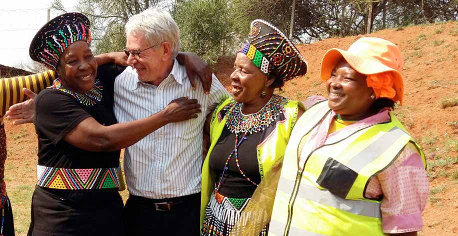 Public Works Deputy Minister Jeremy Cronin with Zibambele Road Maintenance workers.