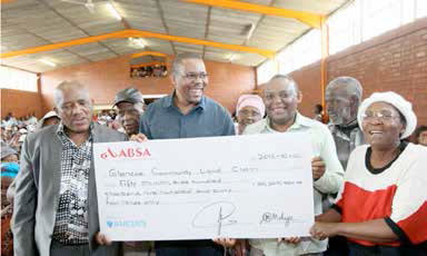 MEC Cyril Xaba (centre) together with Endumeni Local Municipality Clrr Thulani Mahaye, Department of Rural Development and Land Reform Chief Director Mr Nhlanhla Mndaweni and Community representative Mrs Dolly Madela during the official handover of the R50 300 964.00 cheque to the Glencoe Community Land Claimants.