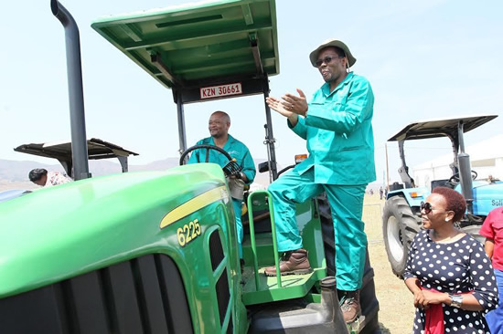 KZN Premier Senzo Mchunu (seated) with KZN MEC for Agriculture and Rural Development Cyril Xaba handing over tractor keys to Phindile Mncube from the Indabuko Women’s Cooperative.