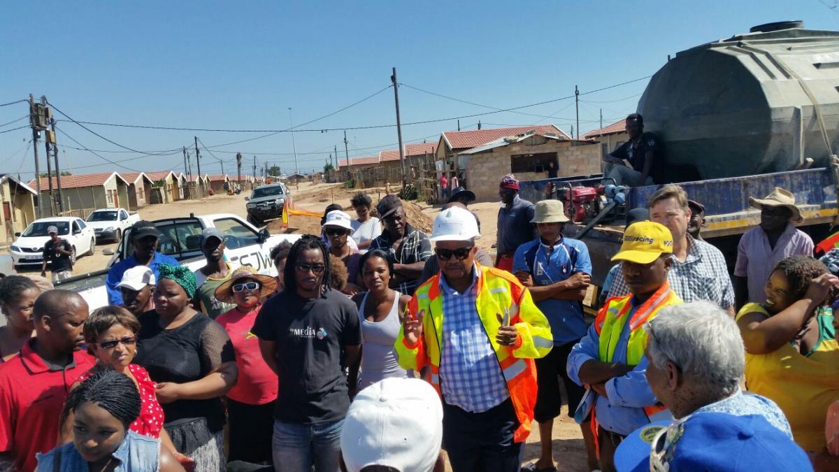 Chairperson of the Infrastructure and Engineering Portfolio at the municipality, Councillor Andile Mfunda (centre), updating the community members of Missionvale, Port Elizabeth, about the work that is taking place in their area.