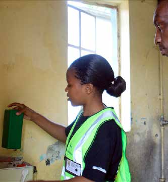 A water agent shows a home owner how drop the block in a toilet tank to save water. The department aims to rollout the blocks to a number of municipalities across the country.