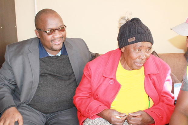 Rand West City Local Municipality Executive Mayor Mzi Khumalo sitting with homeowner Hlengiwe Gretta Dineka inside her new home.