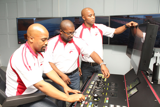 Simulation Training Manager Musa Ngubane (left) with simulation facilitators Thami Khanyile and Vika Njoko demonstrating how the dredging simulator works.