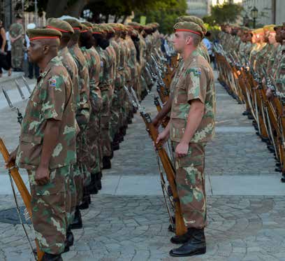 Members of the South African National Defence Force stand in honour of the President.