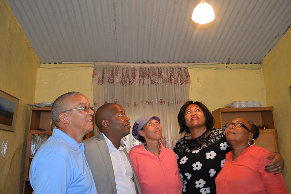 Mayor Mzwandile Masina (centre) joined residents for the switch on in Reiger Park, Boksburg.