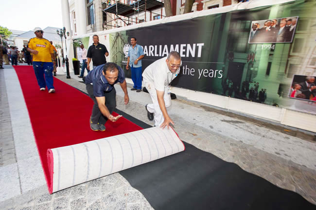 The red carpet being rolled out for invited guests.