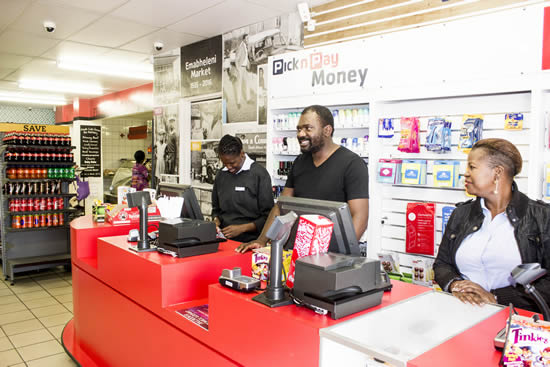 Nkululeko Mbhele shares a joke with colleagues at the Emabheleni Supermarket.