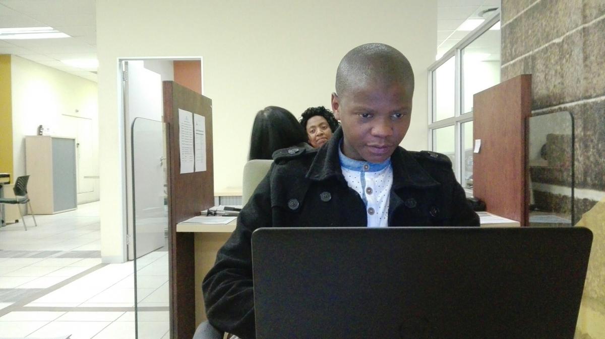 Graduate Tshwaro Mochoari hard at work processing National Student Financial Aid Scheme applications at the Bloemfontein branch of the National Youth Development Agency.