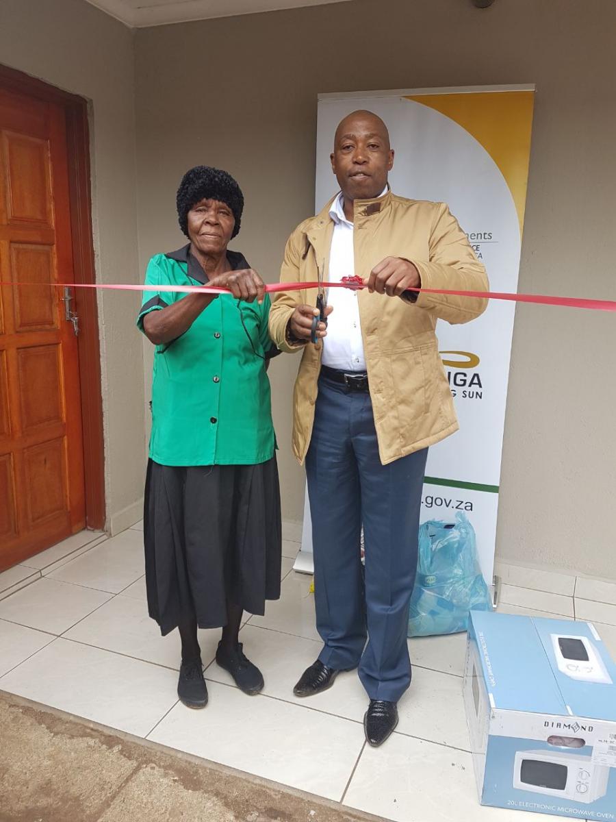 Gogo Saida Sibitane and MEC Speedy Mashilo cutting the ribbon during the official handover of a house to the military veteran. (Photo supplied)