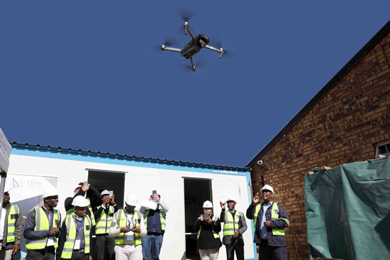 Officials of the DID test flying the drone which is planned to make the monitoring of infrastructure programmes more effective.