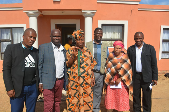 Julia Masilela in the centre and her family outside their newly-built house.